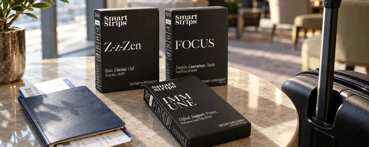 Smart Strips Z-z-Zen, FOCUS and IMMUNE boxes on a hotel lobby table with a passport, boarding pass and carry-on suitcase