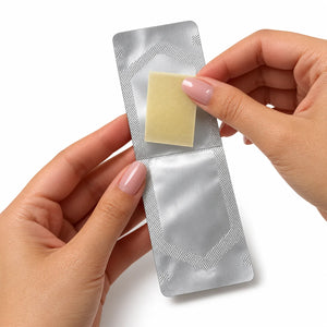 Hands opening a Smart Strips AFTR PARTY sachet to take out the oral dissolvable strip