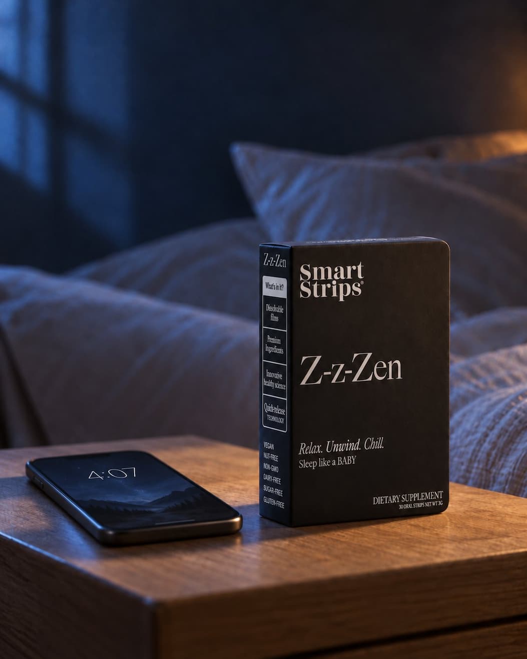 Nightstand with a phone showing 4:07 and a Z-z-Zen box next to it
